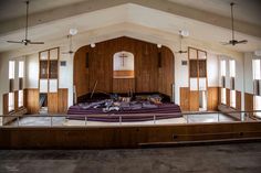 an empty church with wooden walls and pews