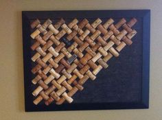 a painting made out of wine corks hanging on a wall