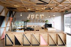 the interior of a restaurant with lots of food and drinks on display at the counter