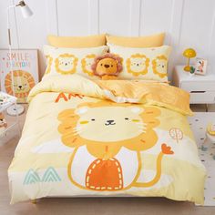 a child's bedroom with yellow and white bedding, lion pillowcases and stuffed animals