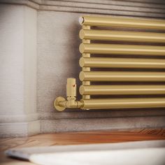 a gold radiator in the corner of a room