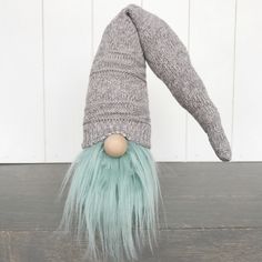 a gray and green gnome hat with long hair