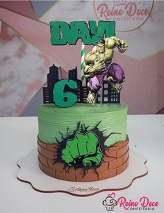 there is a cake that has the hulk on it and number six in front of him