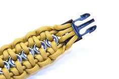 a yellow paracording cord with metal hooks attached to it