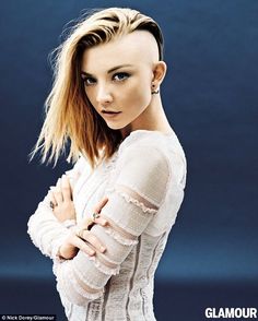 a woman with short hair and piercings posing for a magazine cover photo in front of a blue background