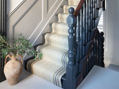 a potted plant sitting on top of a stair case next to a banister