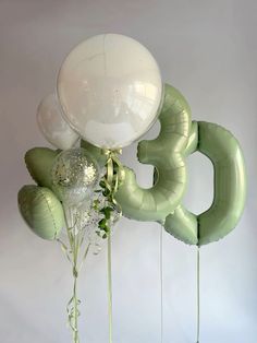 balloons and flowers are arranged in the shape of numbers