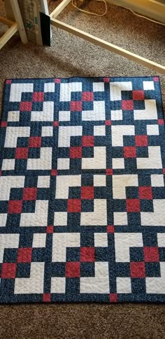 a blue and red quilt sitting on the floor