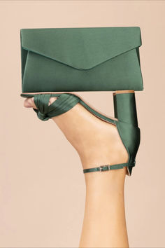 A timeless envelope clutch bag is crafted from gorgeous rich green satin. This handbag closes with a magnetic stud fastening and comes with an optional shoulder chain for ease of wear. Pair with a pair of our blush satin heels to complete your look. Perfect for any special occasion! Matching shoes available. Colour: Green Material: Satin Style: Envelope Clutch Size: 25.6cm x 15.5cm 4.5cm Dyeable: 100% Dyeable Also available in Ivory, Mocha, Midnight and Blush. Envelope Clutch Bag, Satin Heels, Dark Olive Green, Shoulder Chain, Olive Green Color