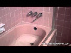 a bathroom with pink tile and white fixtures, including two faucet holes in the bathtub