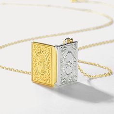 Surprise your loved ones with a treasured keepsake - the Gold and Silver Book Locket Necklace! This exquisite piece features a two-toned gold and silver locket adorned with intricate floral engravings, allowing you to keep cherished memories close. Nestled on radiant 10k gold on brass and accented with shimmering cubic zirconia, it offers a signature finish perfect for best friends, mothers, or partners. A sentimental gift celebrating the bonds you hold dear. 🎁 DETAILS Plating: 10K Gold  Materials: 10K Gold on Silver, Cubic Zirconia Measurements: Length: 15.75 "(40cm)   + Extender: 1.97"(5cm) Pendant Size: 0.47"*0.67"(1.2cm*1.7cm) Weight: 3.8 g Book Locket Necklace, Book Locket, Gold Book, Book And Frame, Photo Locket Necklace, Photo Locket, Silver Lockets, Cherished Memories, Sentimental Gifts