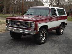 a red and white truck parked in a parking lot