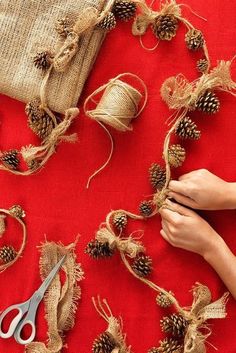 someone is working on some burlap and pine cones