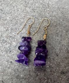 A pair of purple amethyst dangle earrings crafted of 14K yellow gold. These earrings feature stacks of beautiful amethysts, which are a very vivid color! Stamped 14K on the hooks. Measures 1.75" long and weighs 3.7 grams. In very good condition. Will ship in a gift box:-) Stock # E2690 Purple Amethyst Jewelry For Pierced Ears, Purple Amethyst Earrings For Pierced Ears, Gold Amethyst Long Drop Earrings, Purple Gemstone Dangle Earrings, Purple Natural Stone Drop Earrings, Purple Gemstone Accented Dangle Earrings, Gold Amethyst Dangle Chandelier Earrings, Vintage Amethyst Purple Earrings, Purple Amethyst Earrings