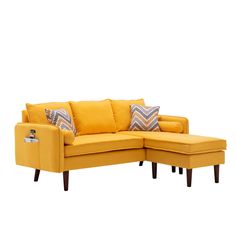 a yellow sectional sofa with pillows on it