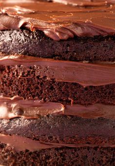 a close up of a cake with chocolate frosting on the top and bottom layers