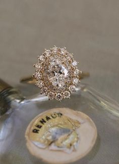 a diamond ring sitting on top of a bottle