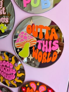 colorful stickers on the side of a pink door that says pop outa this world