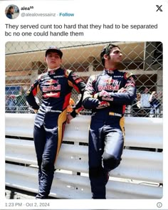 two men sitting on top of a bench next to each other in front of a fence