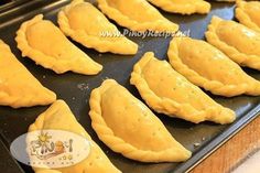 several pastries on a baking sheet ready to be baked in the oven for consumption