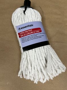 white cotton cord with black tips on the end and an advertise tag for essentials