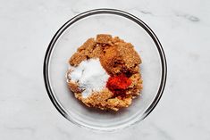 a glass bowl filled with food on top of a white counter