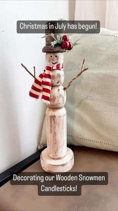 a wooden snowman sitting on top of a table