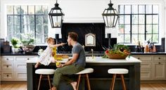 a man sitting at a kitchen counter with a baby