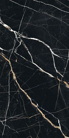 black marble with gold veining and white streaks on the edges is seen in this image