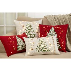 three pillows with christmas trees on them