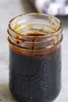 a jar filled with sauce sitting on top of a table