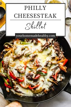 a skillet filled with cheese steak and vegetables