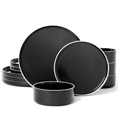 black and white dishes are stacked on top of each other