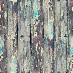 an old wooden wall with peeling paint and chipped paint on the wood planks