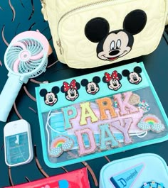 the contents of a mickey mouse purse and other items laid out on top of a table