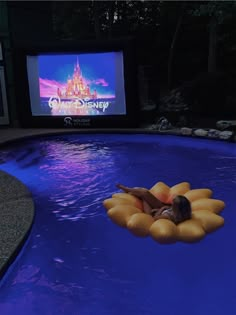 a woman laying on top of an inflatable float next to a swimming pool