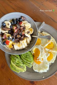 a plate with eggs, avocado and other food on it sitting on a table