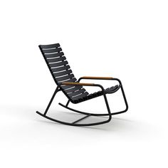 a black rocking chair sitting on top of a white floor