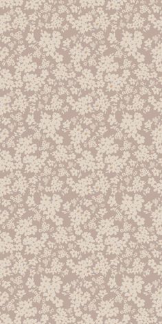 a beige and white flowered background with many small flowers on the top of it