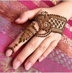 a woman's hand with henna on it