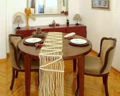 a dining room table with plates and place settings