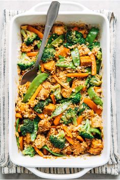 a casserole dish filled with chicken, broccoli and rice