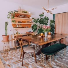 a dining room table surrounded by potted plants and other decorating items on shelves