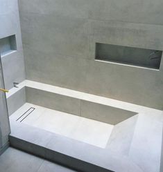 an empty bathroom with concrete walls and floor