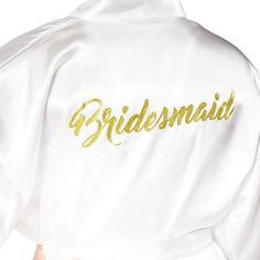 the bridesmaid robe has gold lettering on it