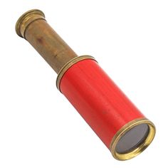 an old red and gold telescope on a white background