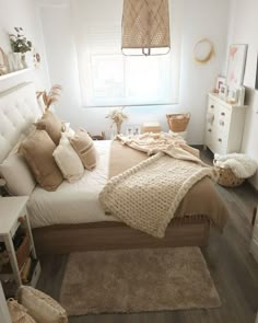 a bedroom with white walls and wooden floors