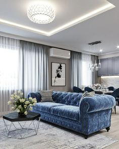 a living room filled with furniture and a blue couch