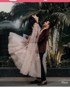 a man and woman standing next to each other in front of a palm tree with the caption's name on it