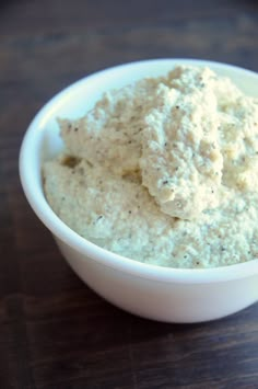 vegan ricotta cheese in a white bowl on a wooden table with text overlay